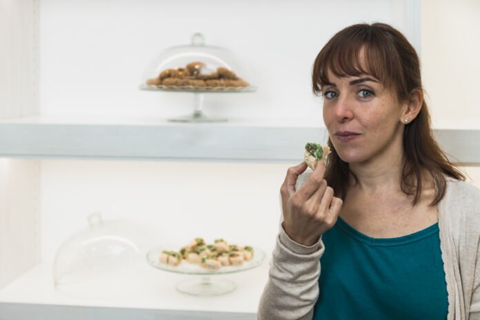 Horizontal photo customer evaluating a pistachio dessert. Copy space. Food and culture concept. Healthy Foods Sabotaging Your Weight